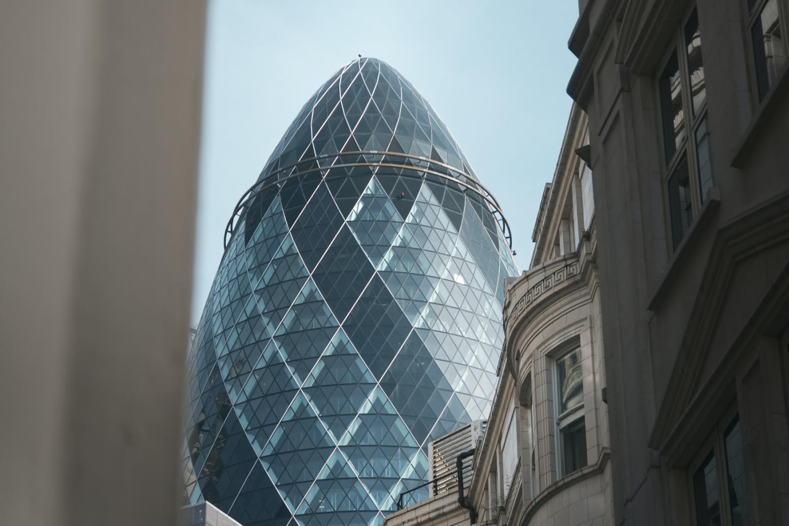A view from the street level looking up at The Gherkin in London's primary financial district.